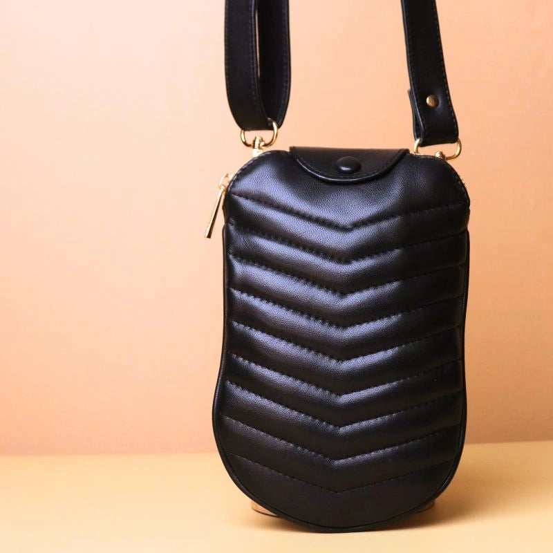 Front view of a small quilted leather sling bag in black leather