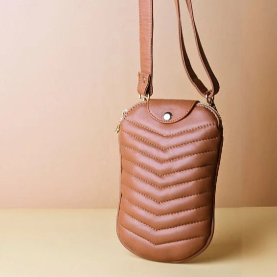 A Tan Leather Quilted Shoulder Crossbody sling pouch bag with its straps extended