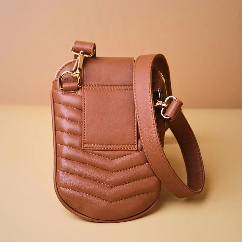 Back View of a quilted leather shoulder crossbody sling pouch bag in tan with a belt hoop and gold fittings