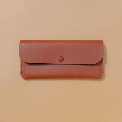 Front view of a leather long wallet for women in tan with flap