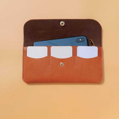 Open flap view of a leather long wallet for women in tan with three card slots , a mobile phone and zip puller