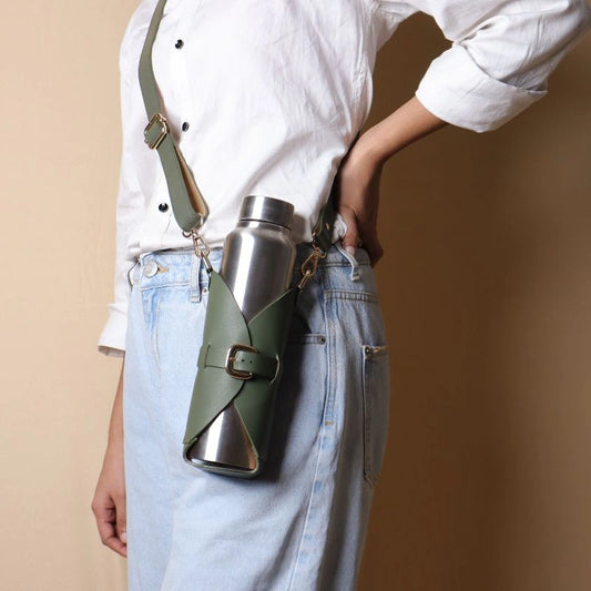 Woman Carrying a Leather Bottle Carrier with a Stainless Steel Bottle with a strap across her shoulder