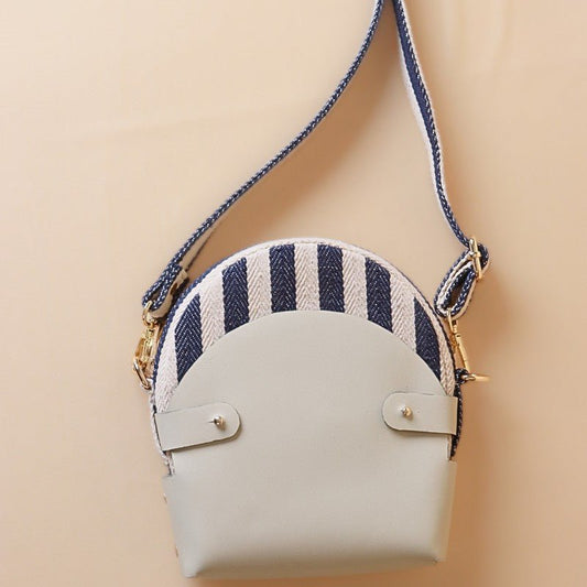 Canvas and Leather slingbag-blue strip canvas body with off-white leather case cotton lining-adjustable and removable shoulder straps-gold plated metal fittings-front view-The Bicyclist